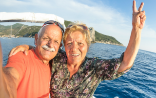 Senior couple enjoying summer trip at the ocean.