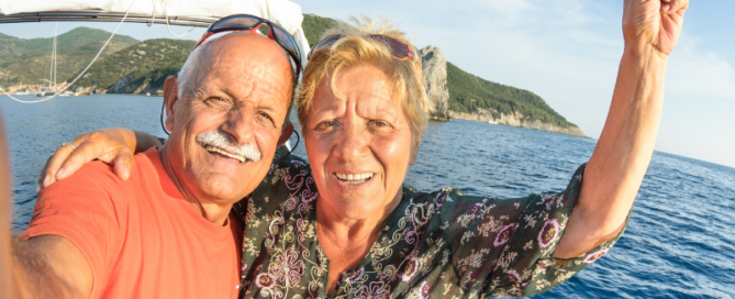 Senior couple enjoying summer trip at the ocean.