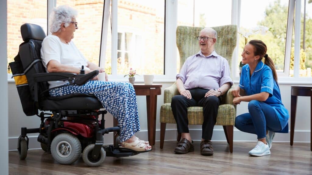 senior living residents talking with caregiver