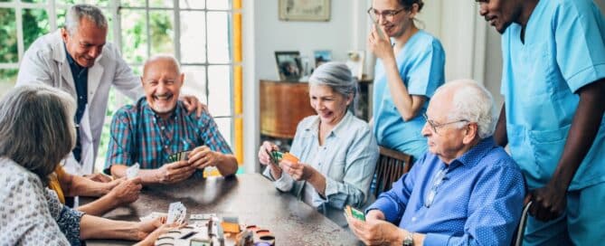 Groups of seniors in assisted living playing cards.