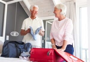 Senior couple packing clothes to bring to assisted living community.