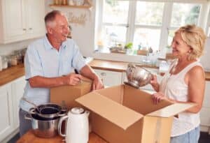 Senior couple packing for kitchen appliances and essentials.