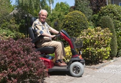 Senior on a mobility scooter.