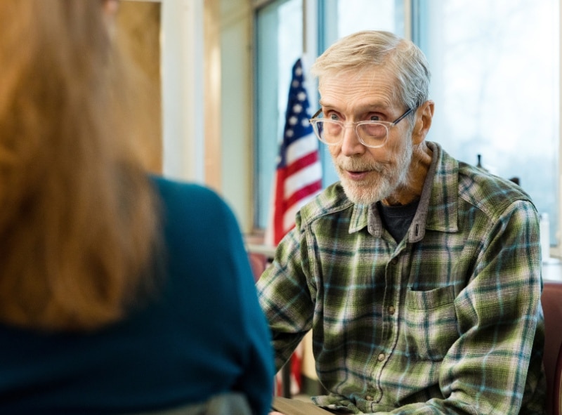 Senior veteran talking with VA personnel.