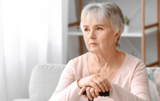 Female senior with dementia looking into the distance.