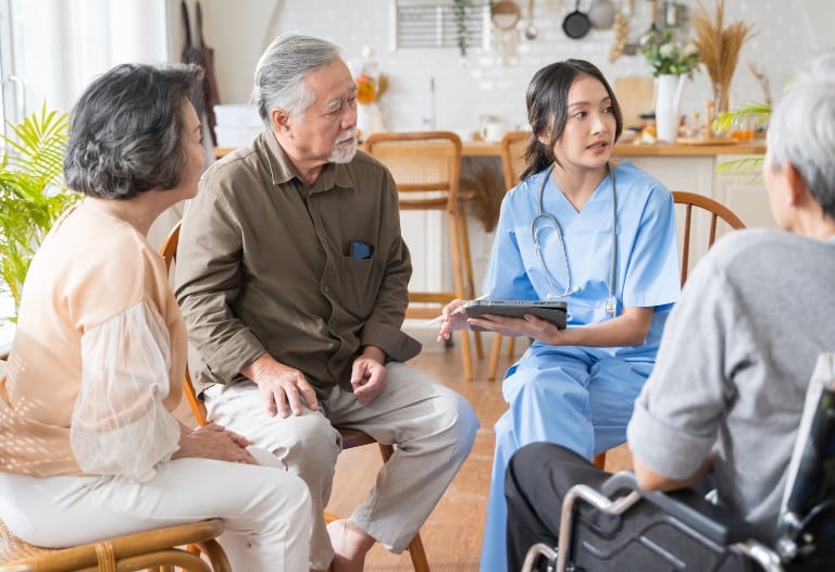 Seniors and family discussing with a female staff in an independent living community.
