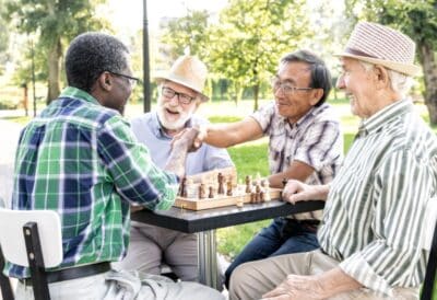 Seniors in assisted living playing chess.