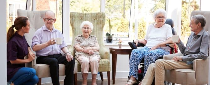 Seniors with a caregiver in an assisted living community.