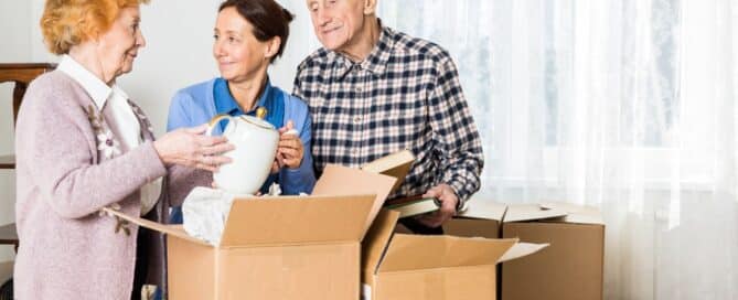 Seniors parents and daughter are helping together to pack things.