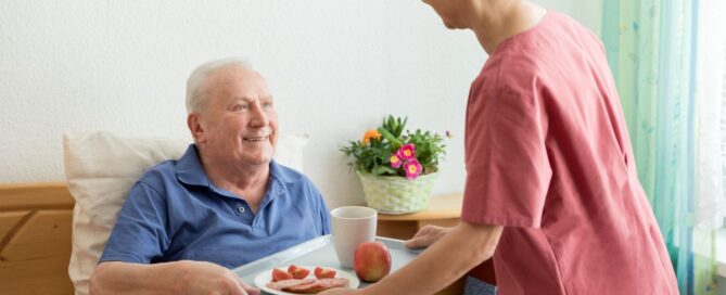 Caregiver helping senior in level 3 in assisted living.