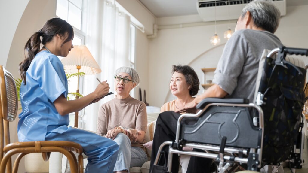 Caregiver in assisted living discussing with three seniors about Caregivers Per Resident in assisted living..