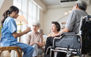 Caregiver in assisted living discussing with three seniors about Caregivers Per Resident in assisted living..