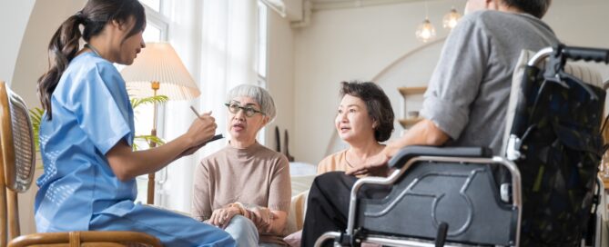 Caregiver in assisted living discussing with three seniors about Caregivers Per Resident in assisted living..