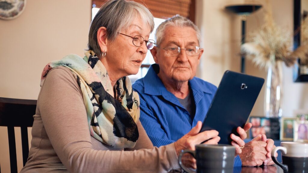 Senior couple using a tablet searching for assisted living.