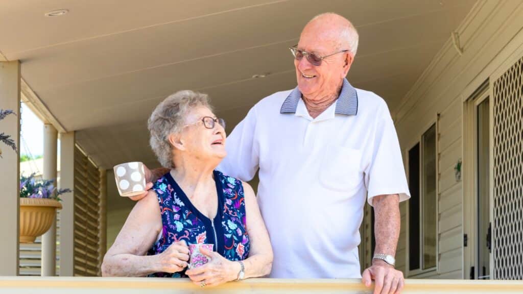 Senior couple holding mugs living in an independent living community.
