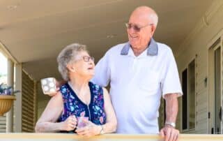 Senior couple holding mugs living in an independent living community.