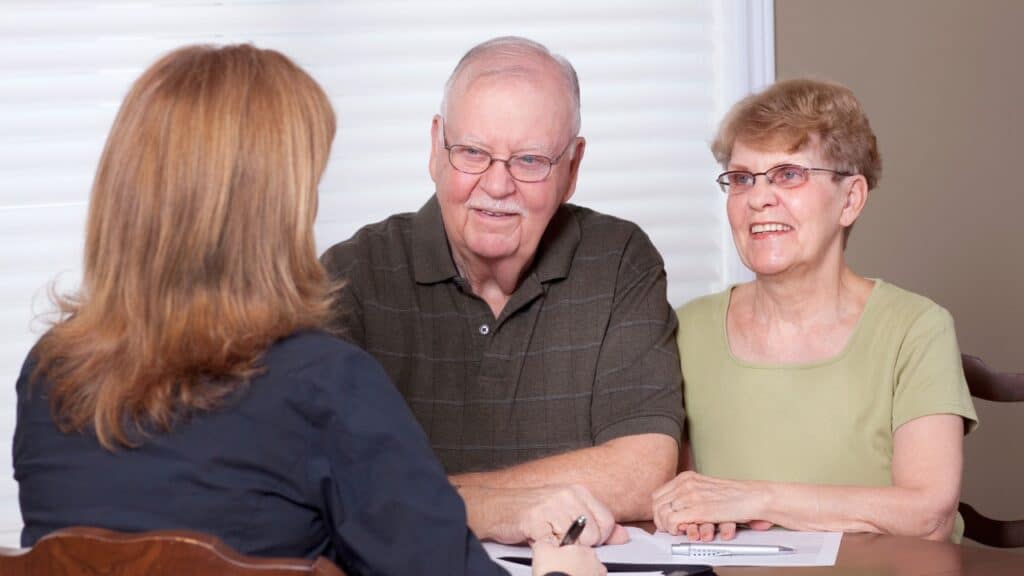 Senior couple talking with a local social worker.
