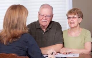 Senior couple talking with a local social worker.