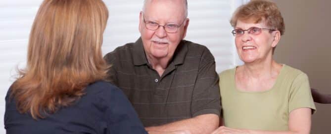 Senior couple talking with a local social worker.