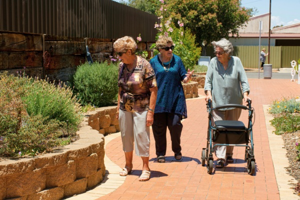 Senior women walking and socializing at the park.