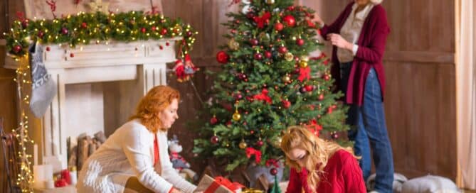 Family include senior family in holiday celebrations, decorating the Christmas tree and wrapping gifts.