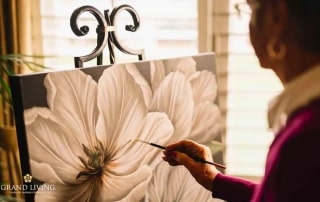 Grand Living at Lakewood Ranch Resident Painting Flower.