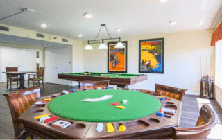 Grand Villa of Sarasota game room with a poker table, chess table, and a pool table.