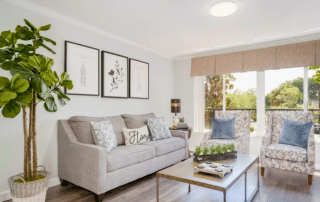 Grand Villa of Sarasota apartment living room with two couches, a coffee table and a potted plant.