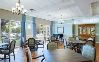 Grand Villa of Sarasota large dining area with tables and chairs.