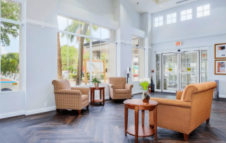 Grand Villa of Sarasota lobby of an apartment building with large windows.