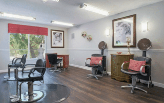 Grand Villa of Sarasota salon room with chairs and a hair dryer.