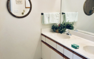 Harbor Inn of Venice South bathroom with two sinks and a mirror.