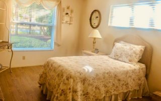 Harbor Inn of Venice South bedroom with a bed, dresser and window.