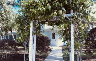 An arbor in front of a Harbor Inn of Venice facility.