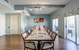 Heron Club at Prestancia private dining with long table and chairs set-up.