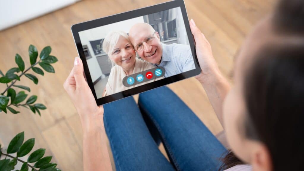 Parents and daughter video calling to manage senior living decisions from afar.