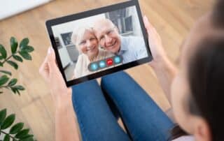 Parents and daughter video calling to manage senior living decisions from afar.