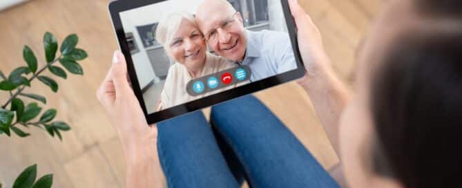 Parents and daughter video calling to manage senior living decisions from afar.