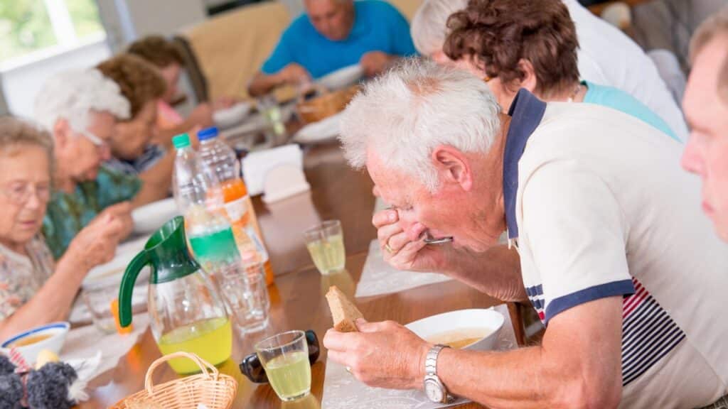 Group of seniors having lunch in an adult day care center.