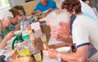 Group of seniors having lunch in an adult day care center.