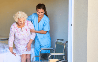 Caregiver helping elderly person in a nursing home