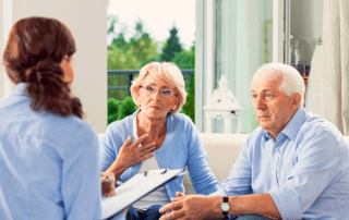 Senior couple meet with senior care advisor for assisted living cost guidance.