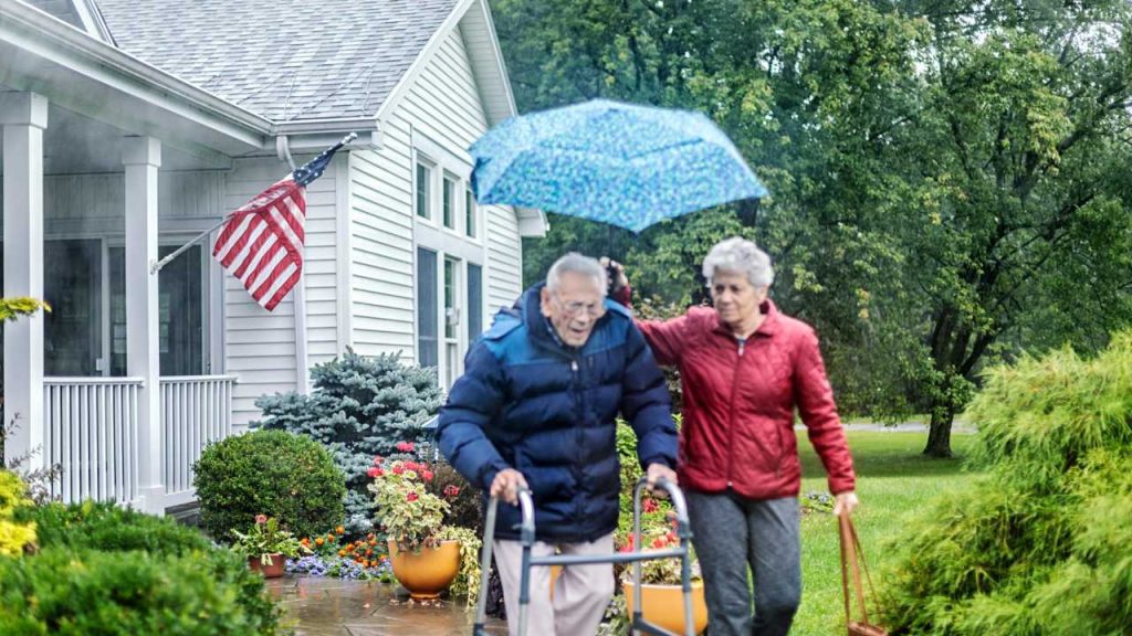 Proud veteran with American Flag at their house - benefits for senior living 2025 guide.
