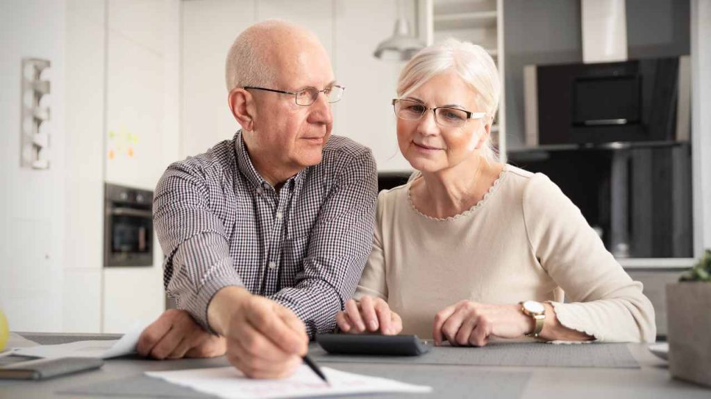 Senior couple doing calculation for senior living