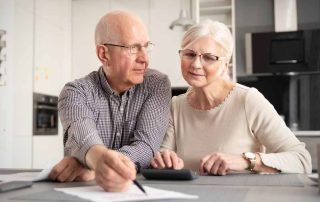 Senior couple doing calculation for senior living