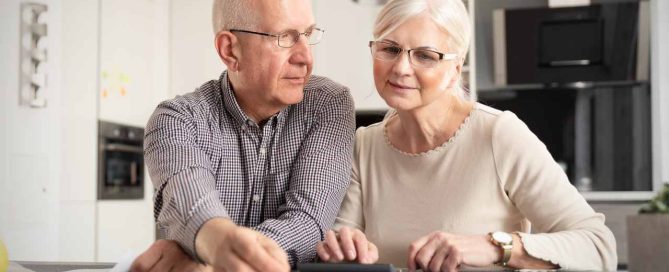 Senior couple doing calculation for senior living