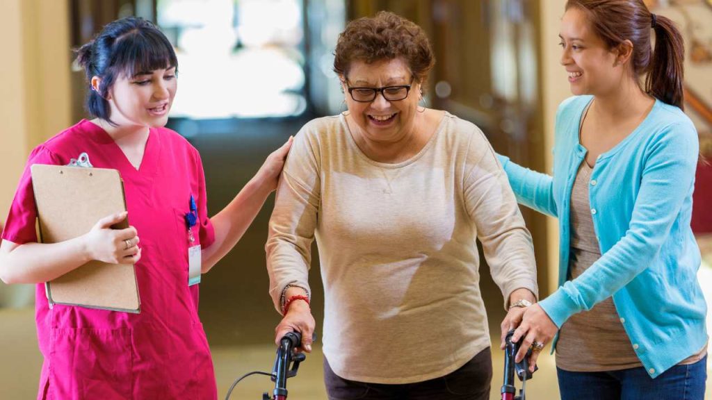Caregiver explaining the Types of Senior Living a senior and family member.