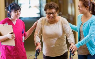 Caregiver explaining the Types of Senior Living a senior and family member.