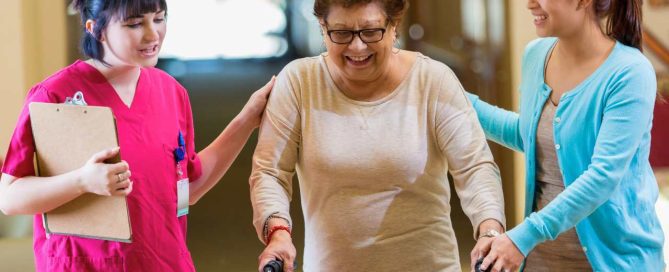 Caregiver explaining the Types of Senior Living a senior and family member.