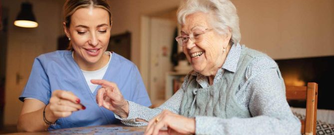Companion caregiver playing puzzle with a senior.